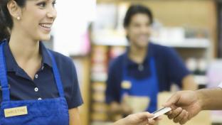 Closeup of a hand giving female employee loyalty card
