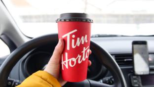 Winnipeg, Manitoba / Canada - February 17, 2020: Holding a Tim Hortons Large Cup of Coffee.