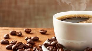 Coffee cup and coffee beans on table